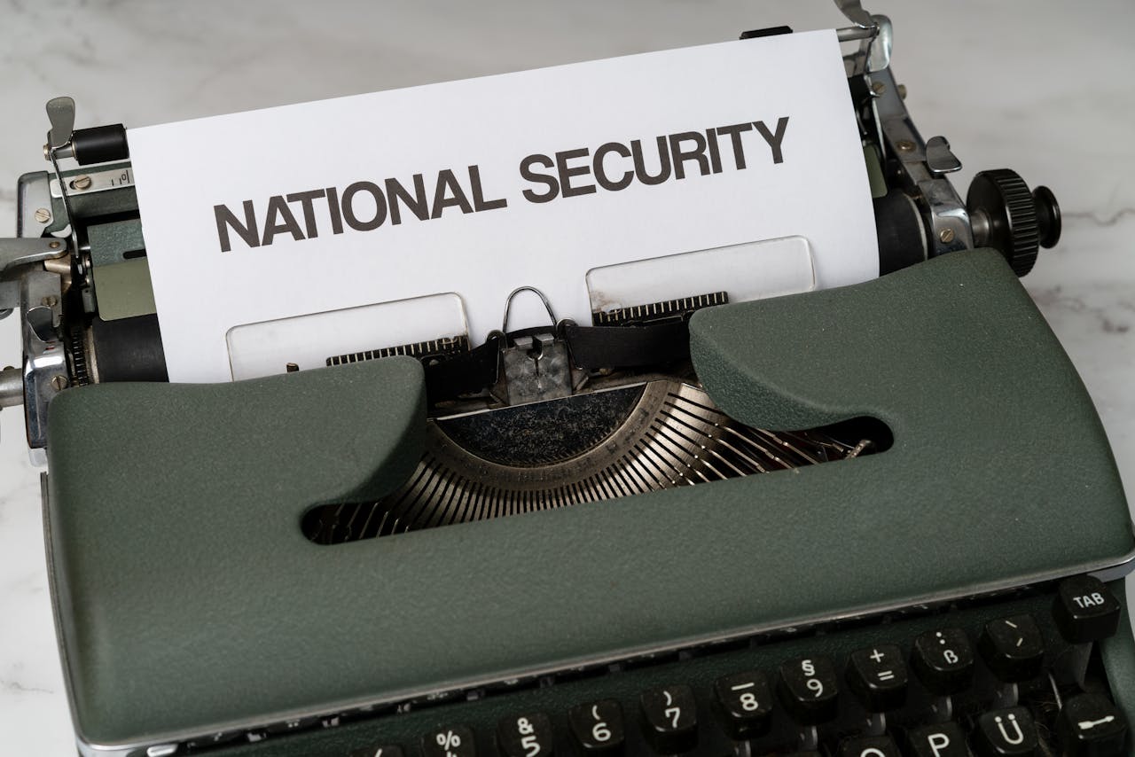 Close-up of a vintage typewriter with a paper marked National Security, symbolizing confidentiality.